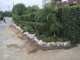River Rock planter wall with street lighting for night.