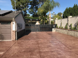 Our custom work: Stamped colored driveway, wrought iron fencing, block walls, and lighting.